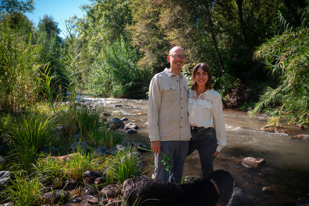 Documentary subjects beside a shaded creek